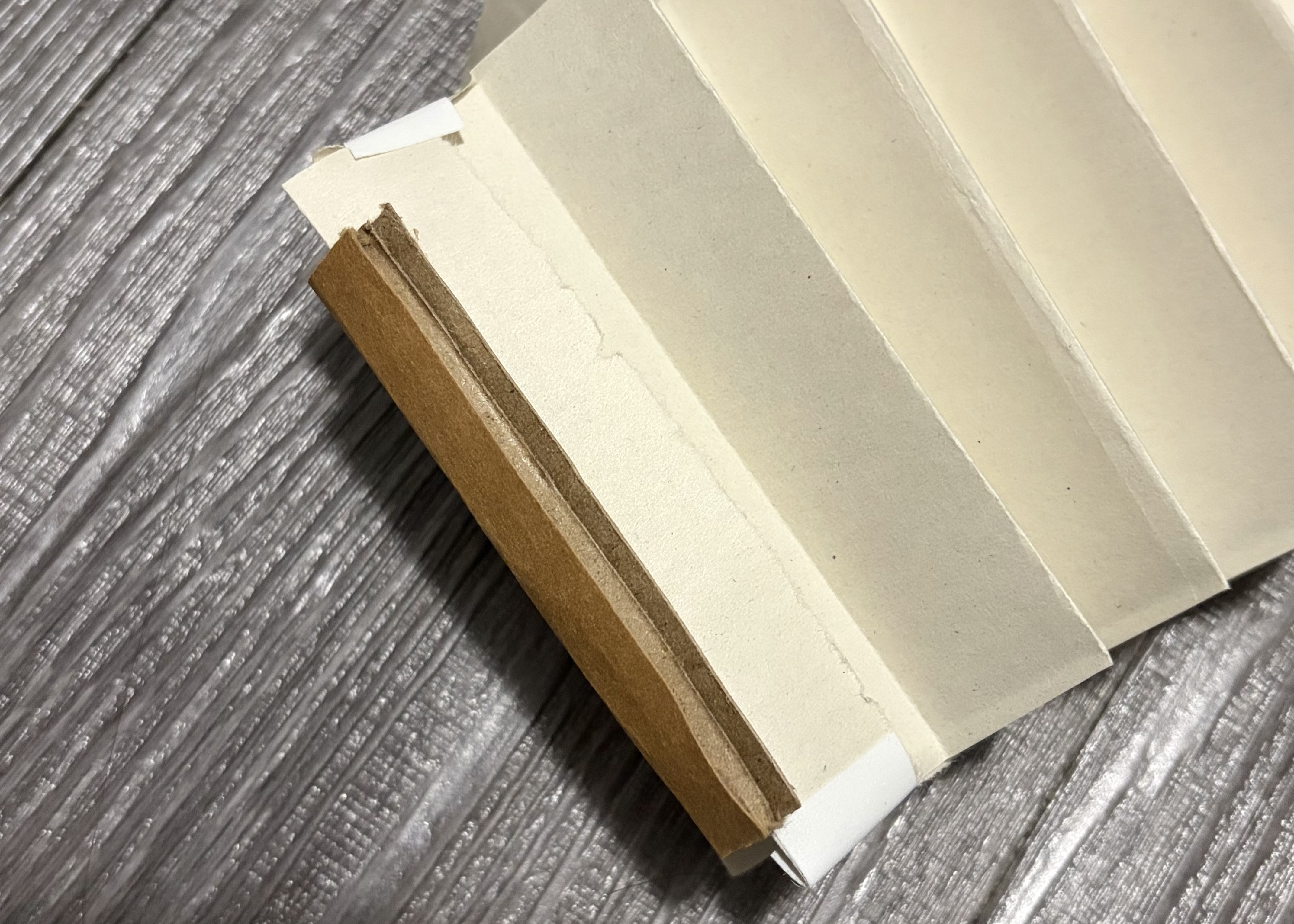 Reinforcing corners of the paper with cardboard to make it more sturdy
